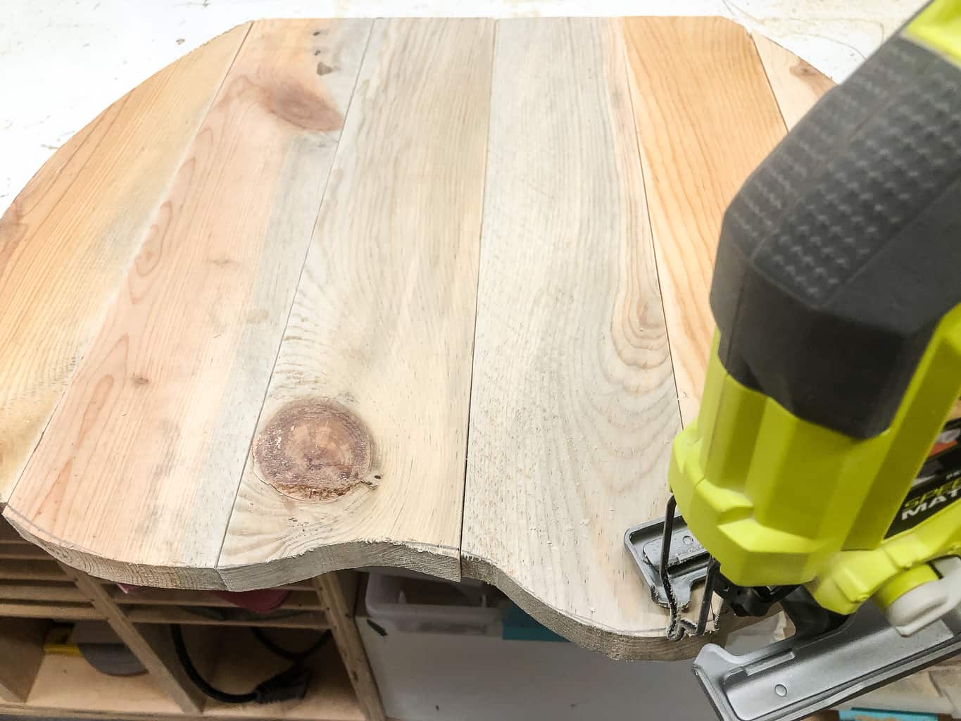 trimming uneven edges of the pallet pumpkins with a jigsaw