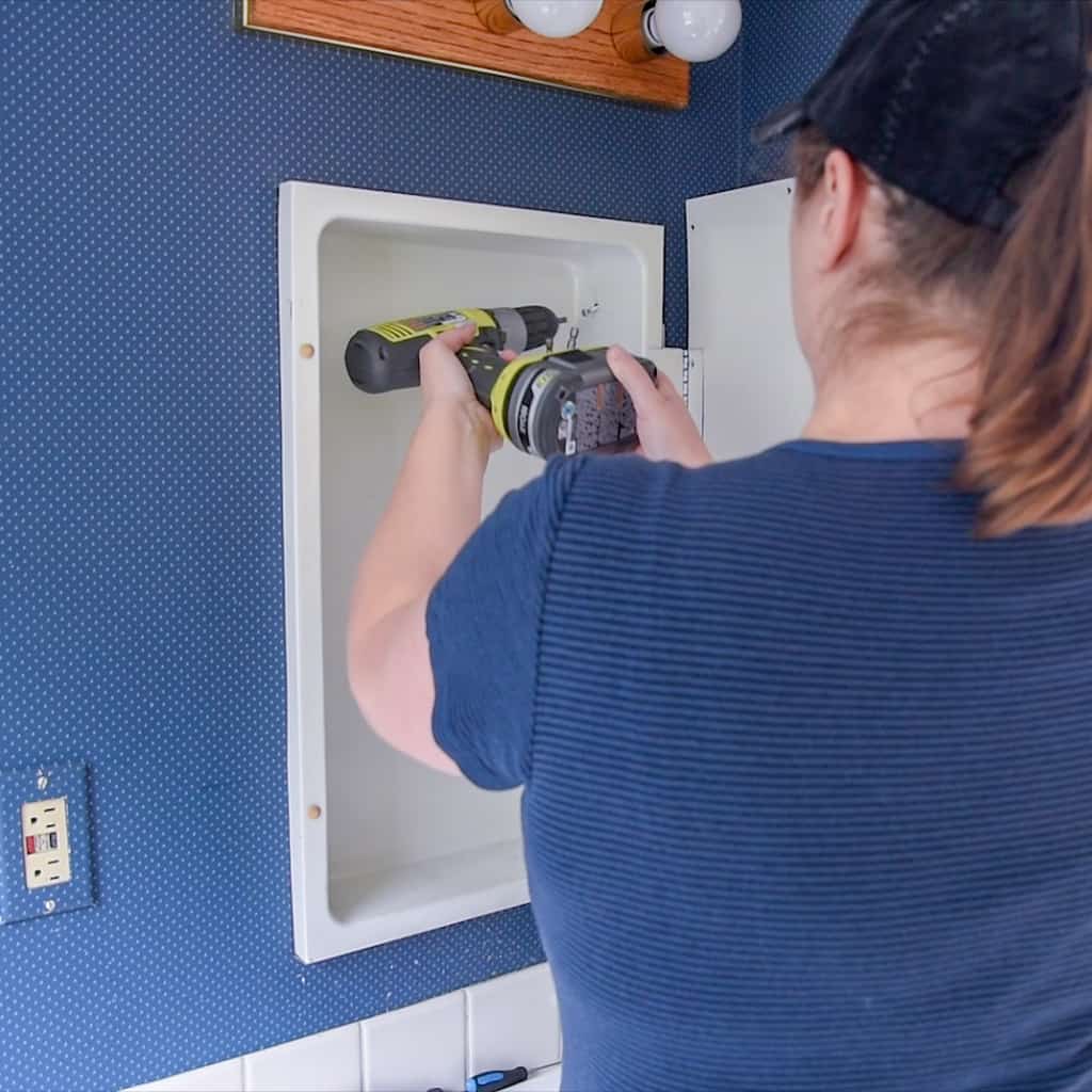 Removing screws from inside of medicine cabinet