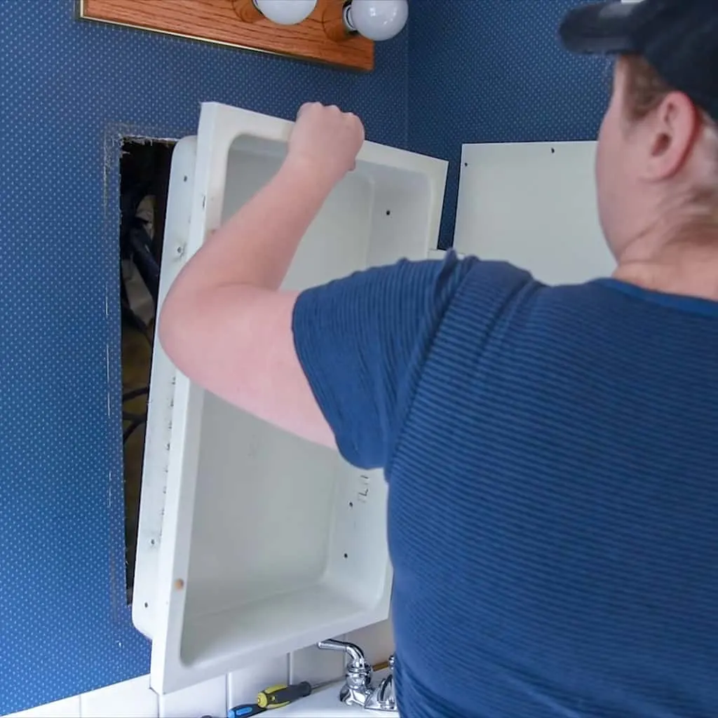 removing a medicine cabinet from the wall
