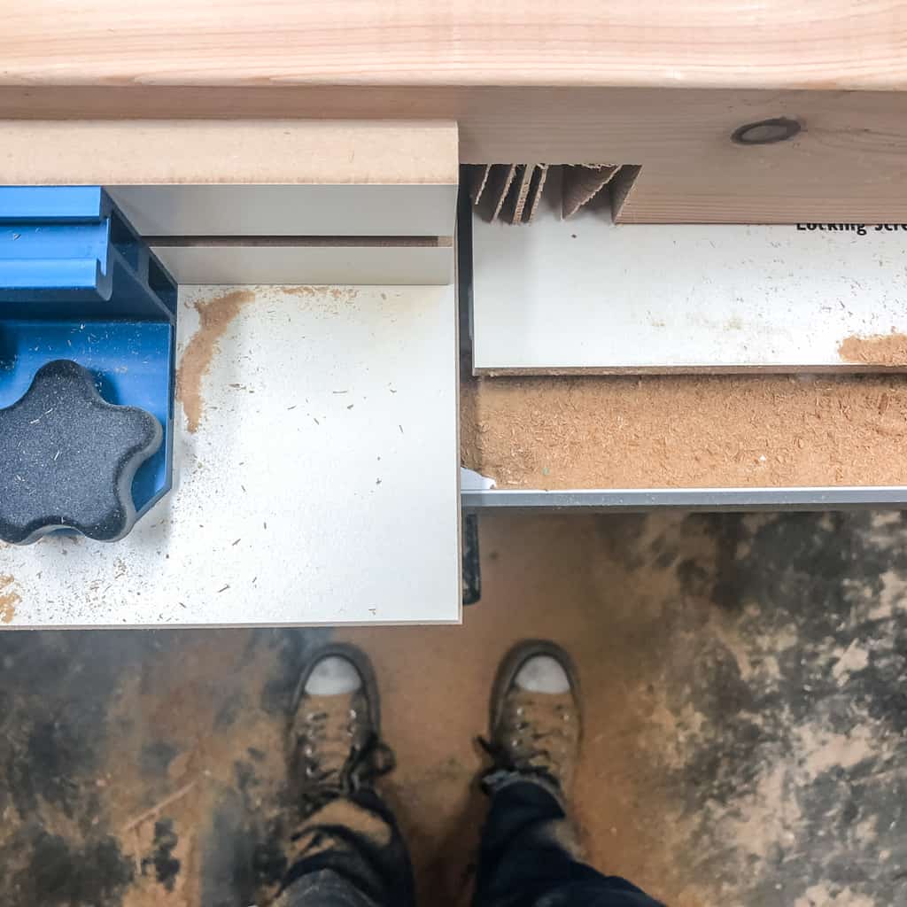 cutting half lap joints on the table saw with lots of sawdust covering feet