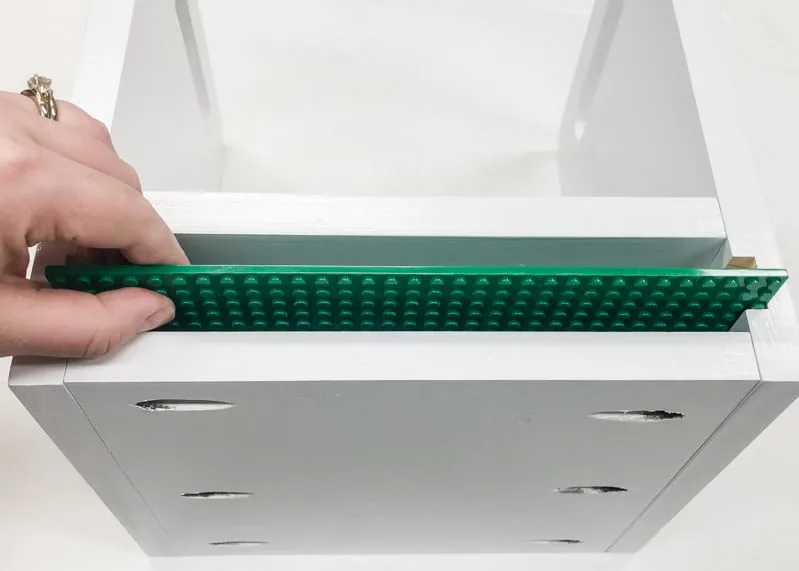testing fit of Lego baseplates in Lego bin