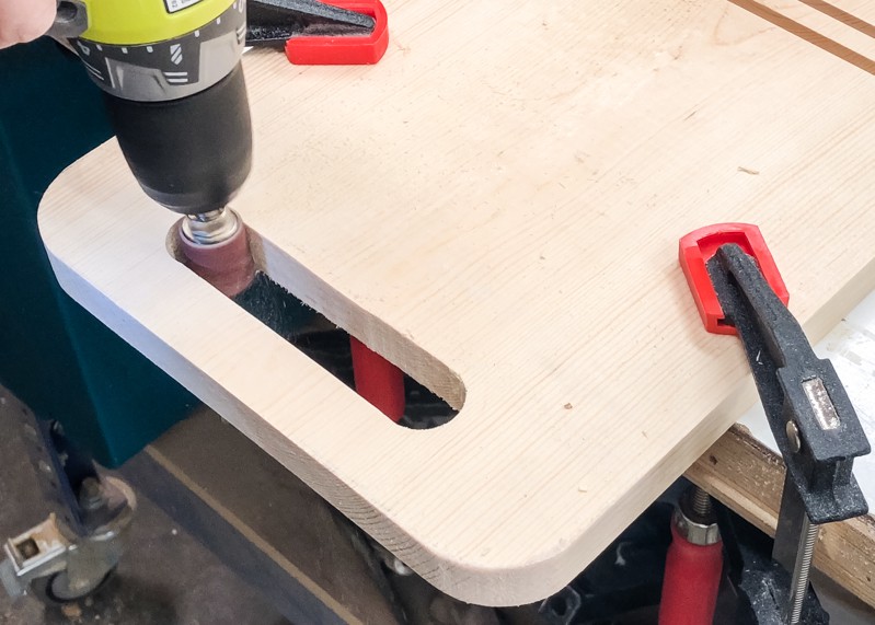 Using a drum sander to sand inside of handle of DIY Lego bin