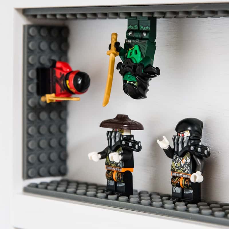 lego minifigure display shelf with minifigures on sides and upside down