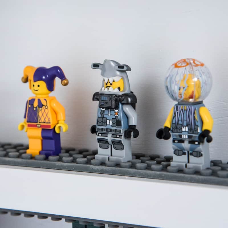 three odd Lego minifigures on DIY Lego minifigure display shelf