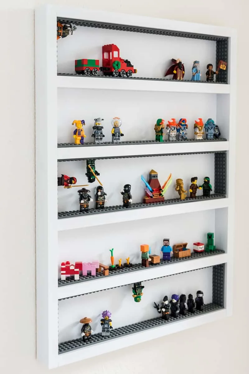 six shelf Lego minifigure display case with adhesive Lego strips