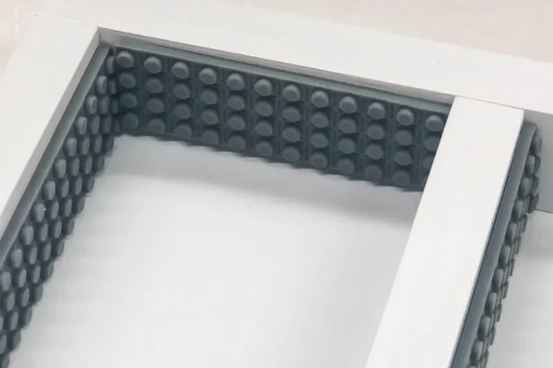 adding adhesive Lego tape to sides of minifigure shelves