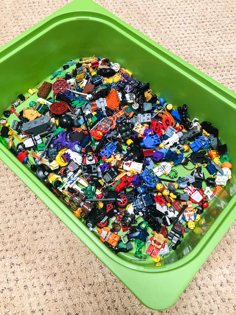 Lego minifigures in green plastic bin