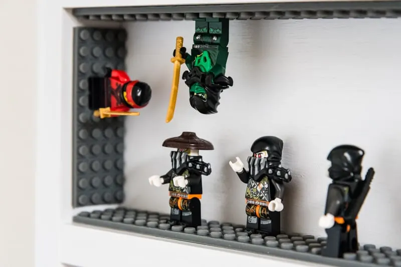 Lego Ninjago minifigures battling in DIY minifig display case