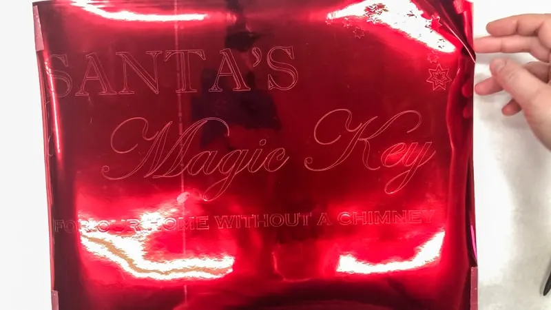 Santa's Magic Key sign text cut from shiny red vinyl on a Silhouette machine