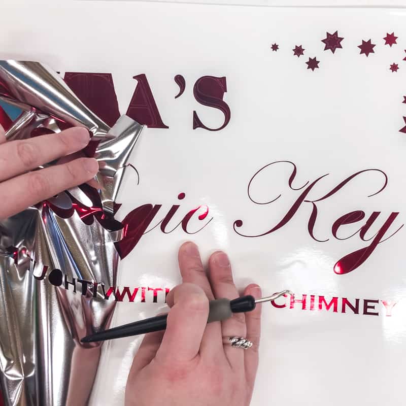 Removing excess vinyl from Santa's Magic Key sign text