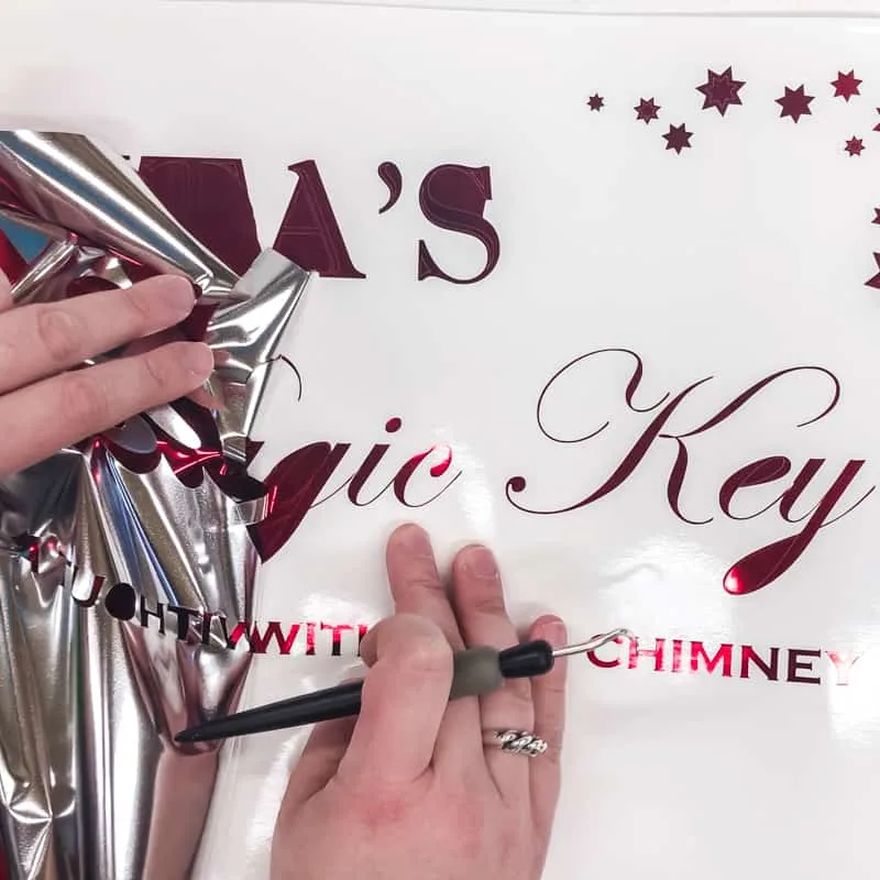 Removing excess vinyl from Santa's Magic Key sign text