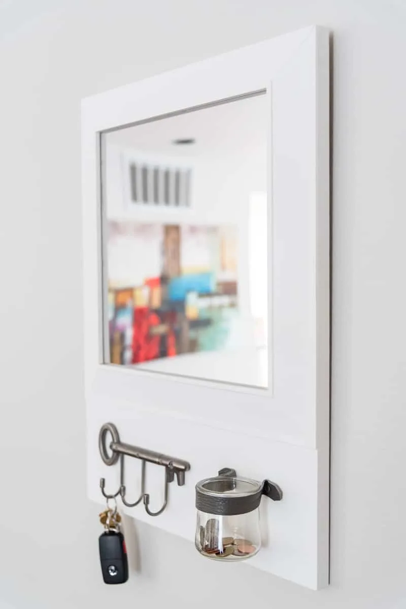 DIY entryway mirror with key hooks and change jar