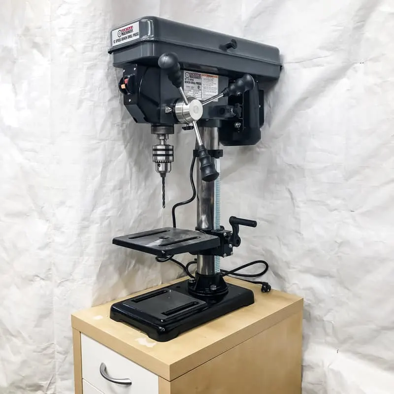 drill press on IKEA cabinet stand with white tarp background