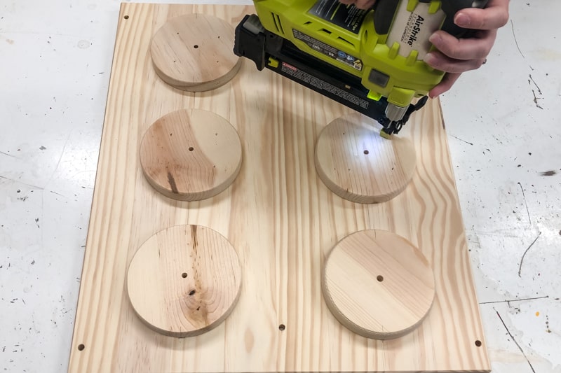 nailing circles to side of IKEA Trofast frame to resemble Lego bricks