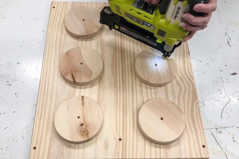 nailing circles to side of IKEA Trofast frame to resemble Lego bricks