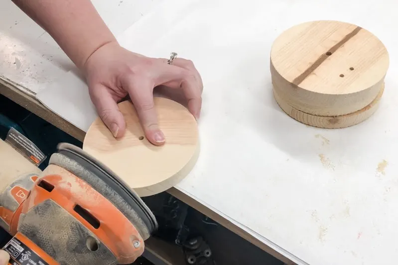 sanding the cut edge of 5" wooden circles for IKEA Lego table hack