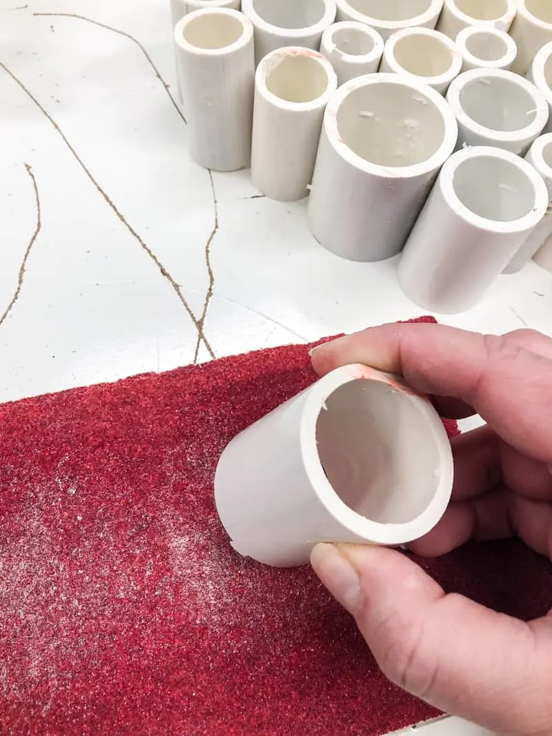 sanding ends of PVC pipe with 80 grit sandpaper