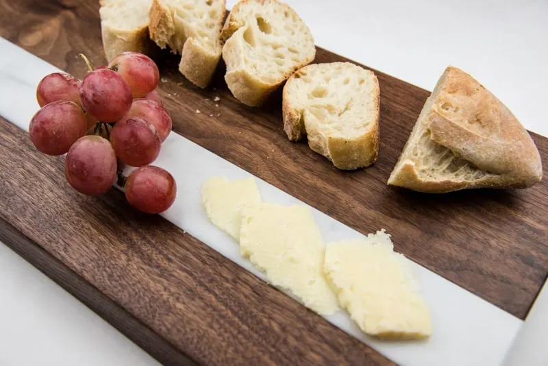 cheese and bread on DIY cutting board with marble inlay