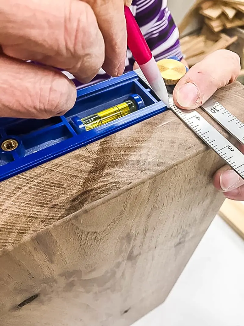 marking the width and depth of the marble on the edge of the walnut board