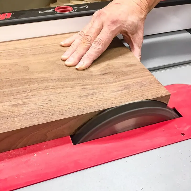 squaring up the edge of the cutting board with the table saw