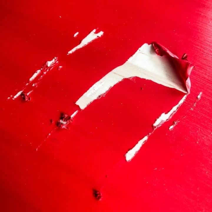 peeling red paint on pine furniture