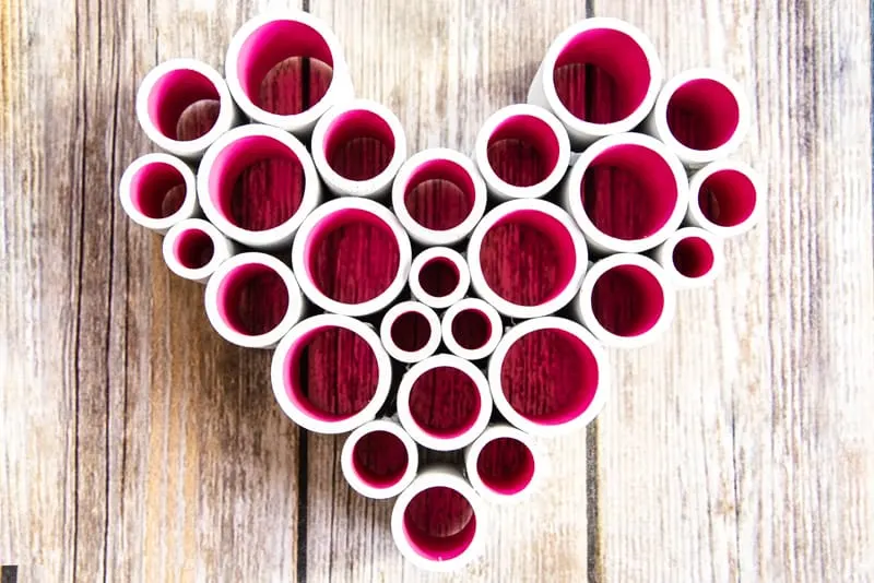 PVC pipe heart on a wood background