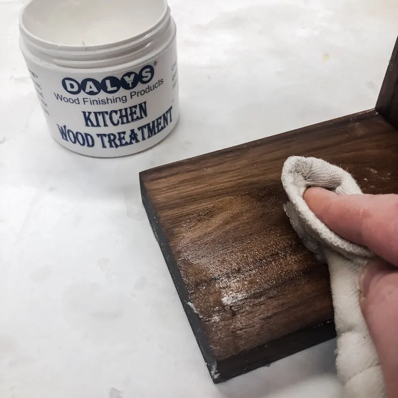 applying cutting board wax to surface of DIY spice rack