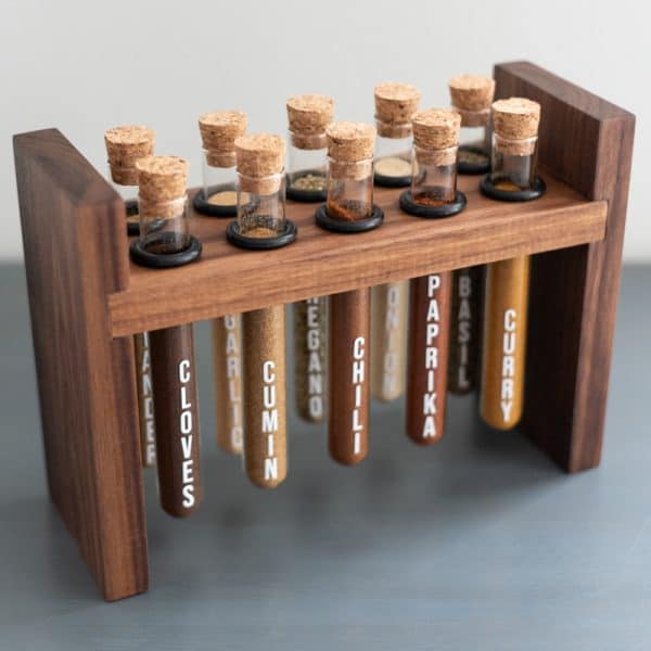 DIY spice rack with test tubes suspended from walnut frame