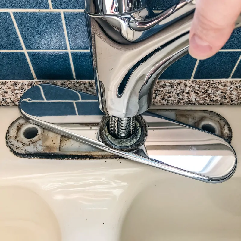 pulling out old kitchen faucet