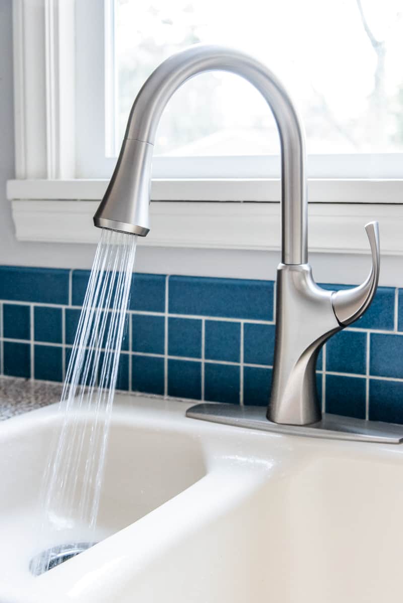 new kitchen faucet spraying water into sink