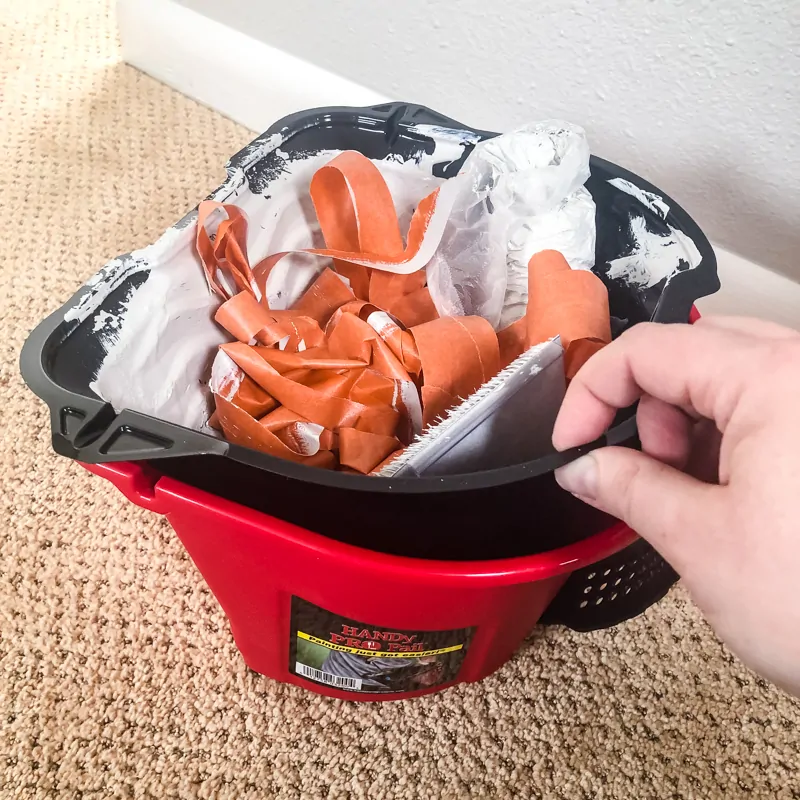 HANDy PRO pail liner filled with painter's tape and roller cover