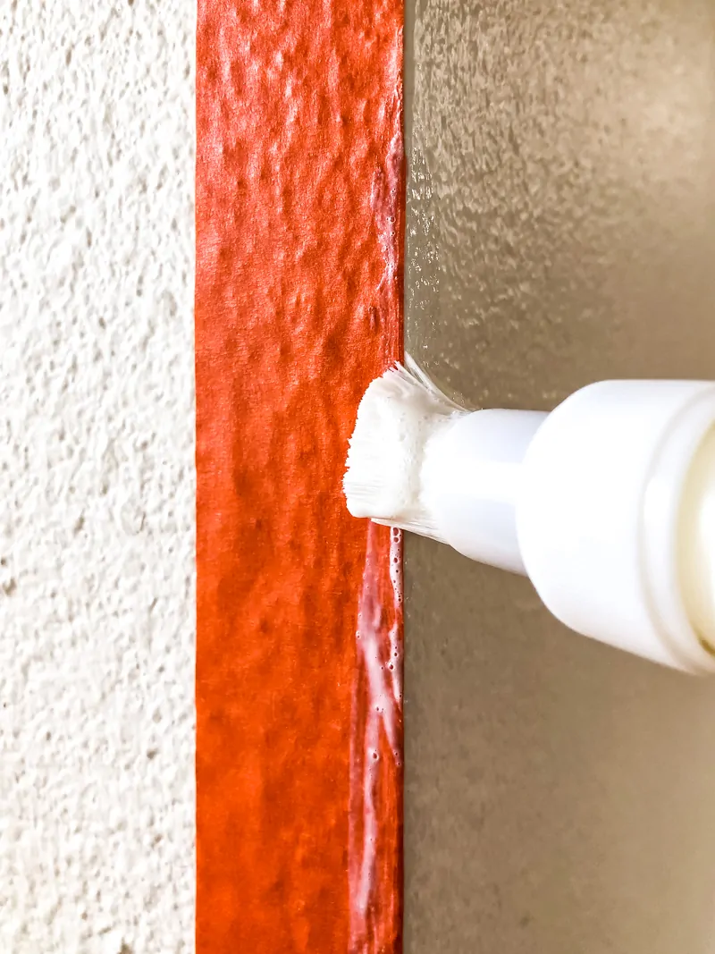 applying Frogtape Textured Wall Tape and Sealer to corner of textured wall surface