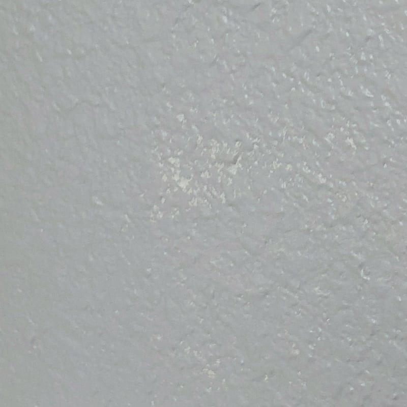 spotty paint coverage on textured wall