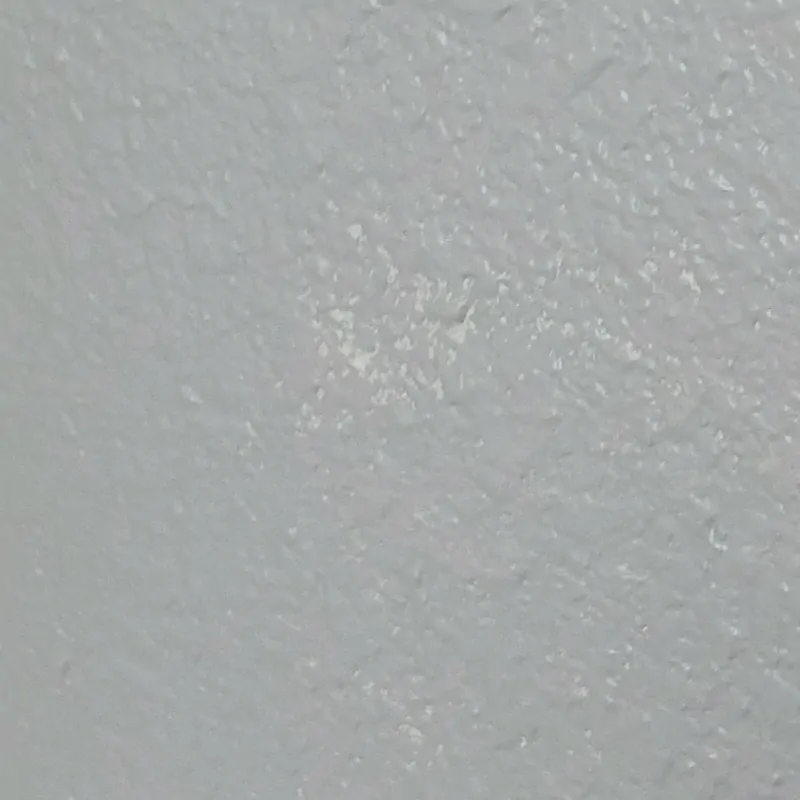 spotty paint coverage on textured wall