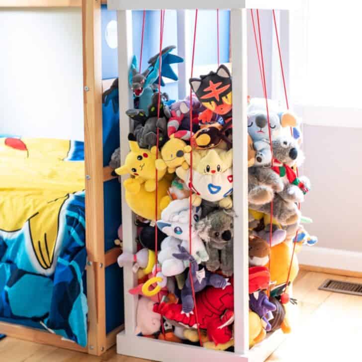 DIY stuffed animal zoo next to child's bed