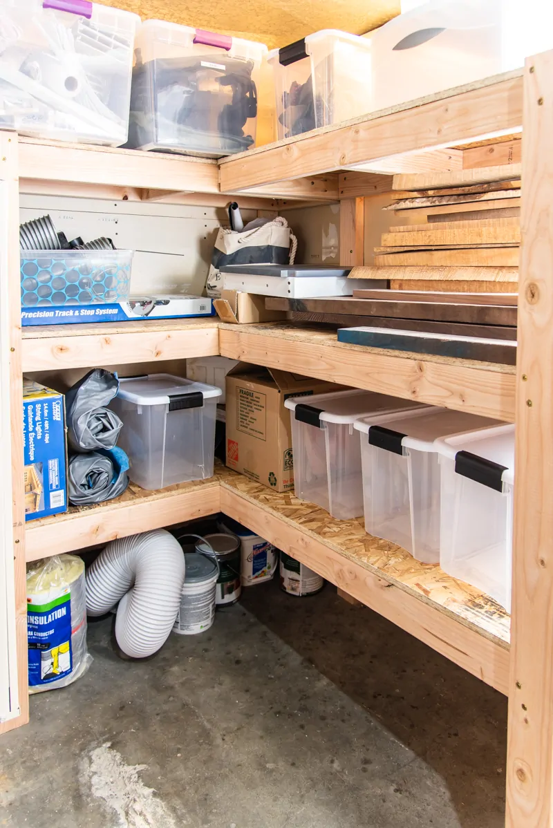 DIY corner storage shelves with plastic bins and paint cans
