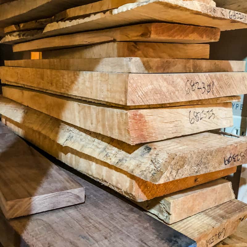 garage shelf full of hardwood boards