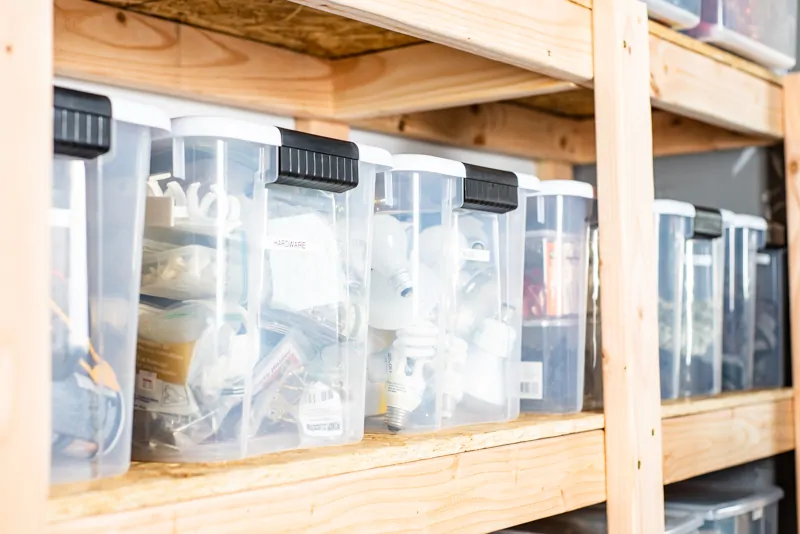 plastic bins on DIY garage shelves