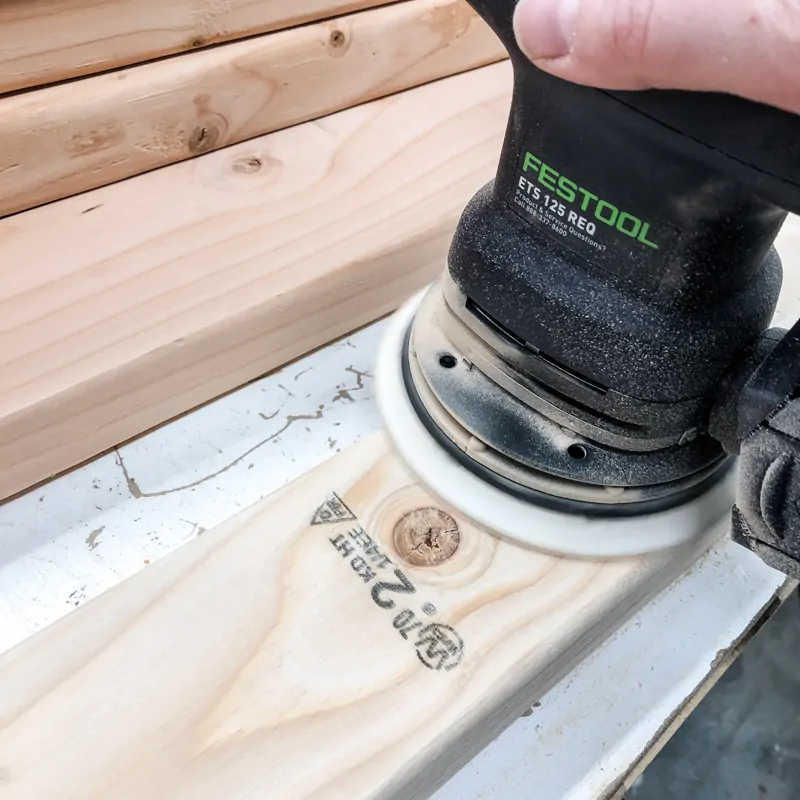 sanding pieces of DIY garage shelves with Festool sander