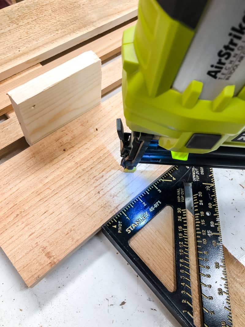 nailing slats of potting bench back in place with a brad nailer