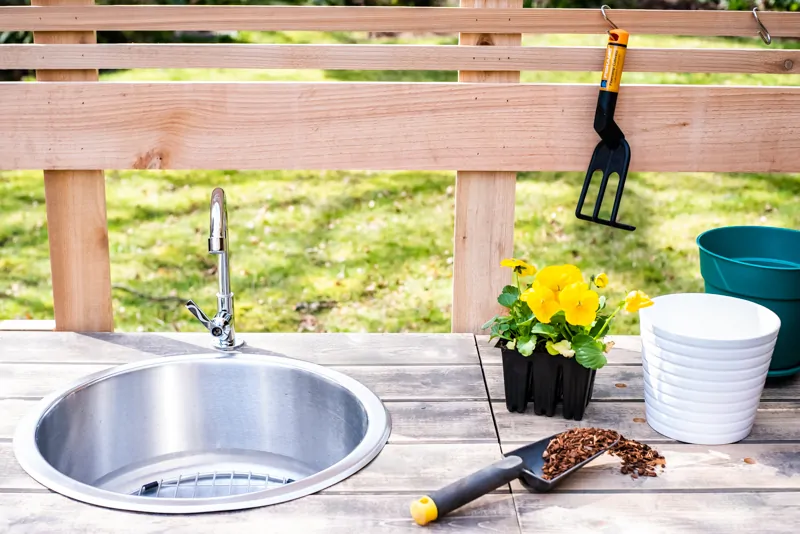 potting bench sink with flowers and gardening tools