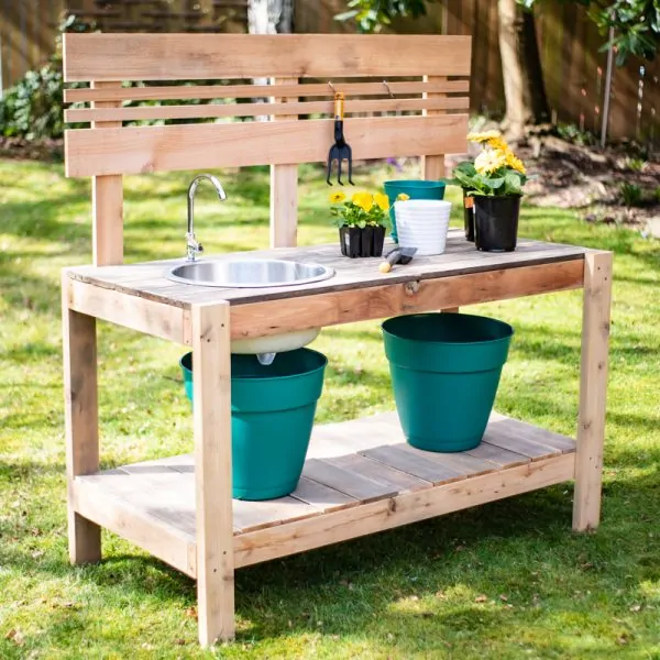 DIY potting bench with sink in grass