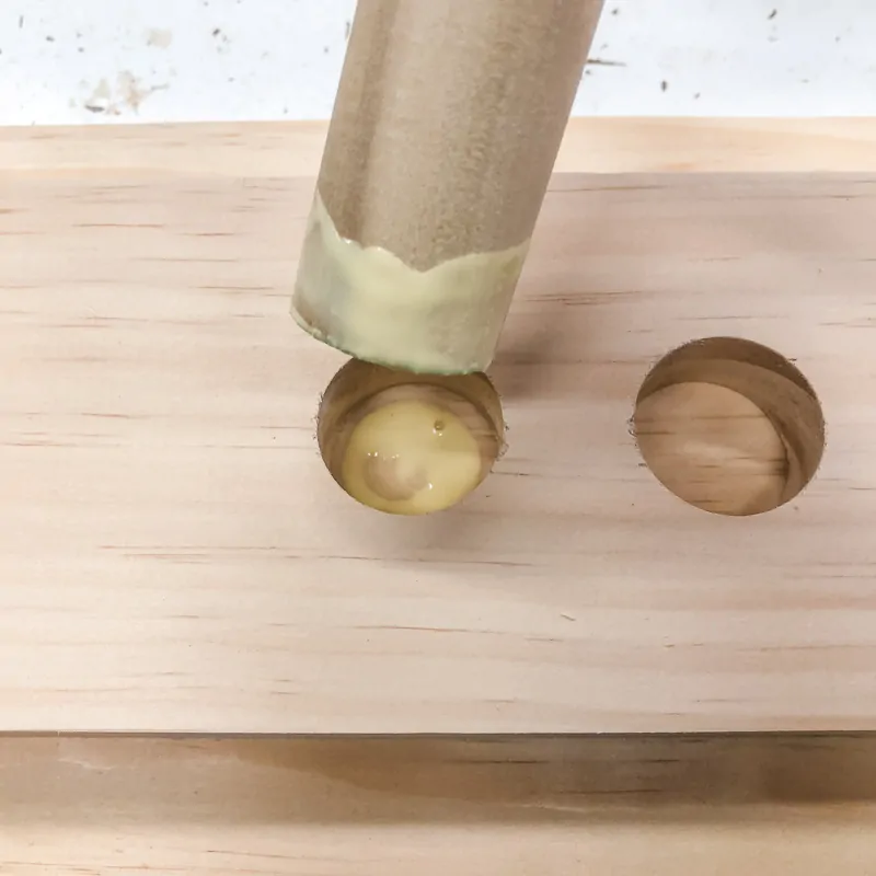 wood glue on bottom of hole and end of dowel