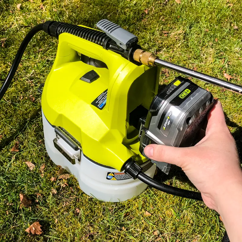 inserting battery into Ryobi chemical sprayer