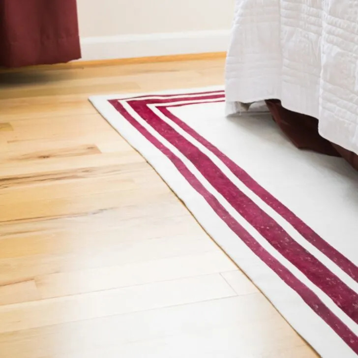 DIY area rug made from a drop cloth with painted stripes