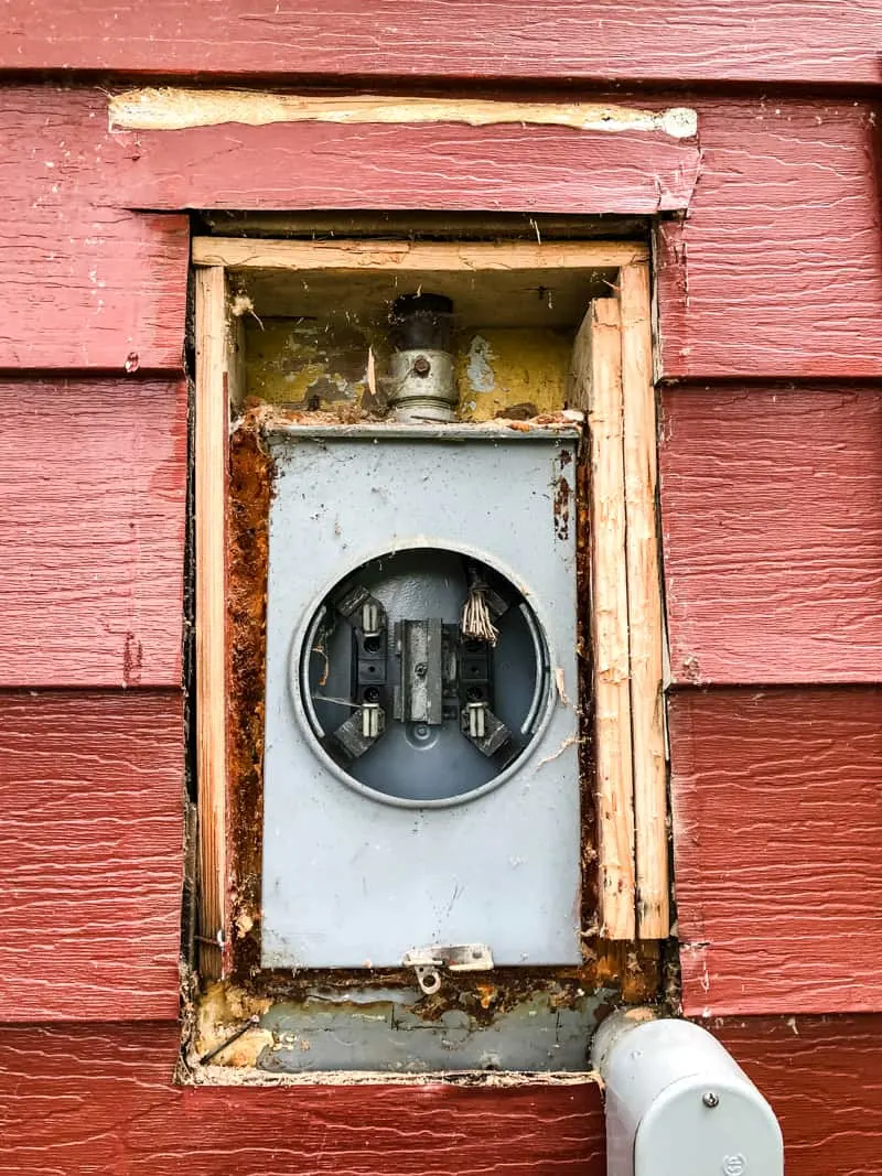 old electric meter in siding of house