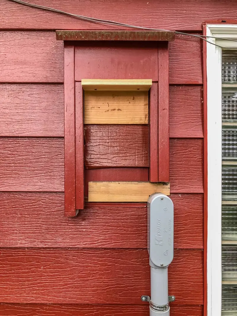 old electric meter framed into siding