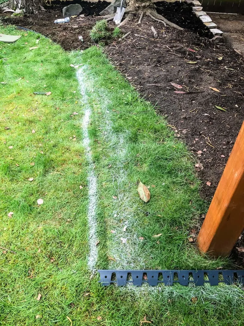 marked grass for pea gravel patio