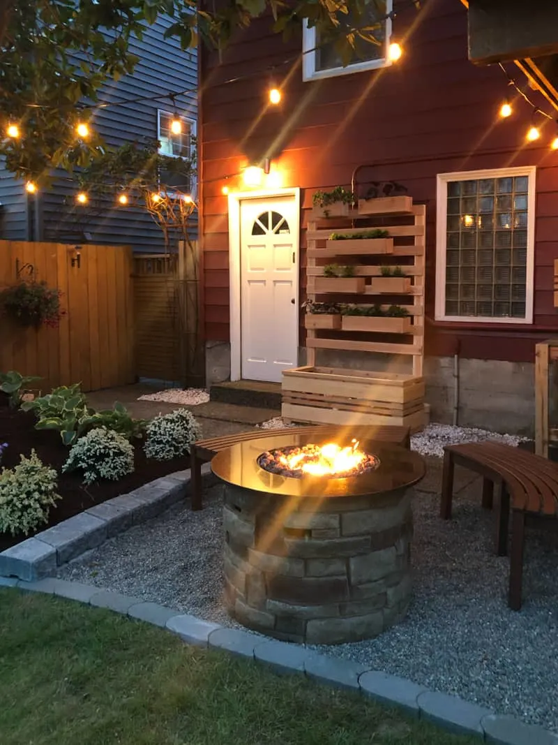 backyard makeover with string lights and propane fire pit