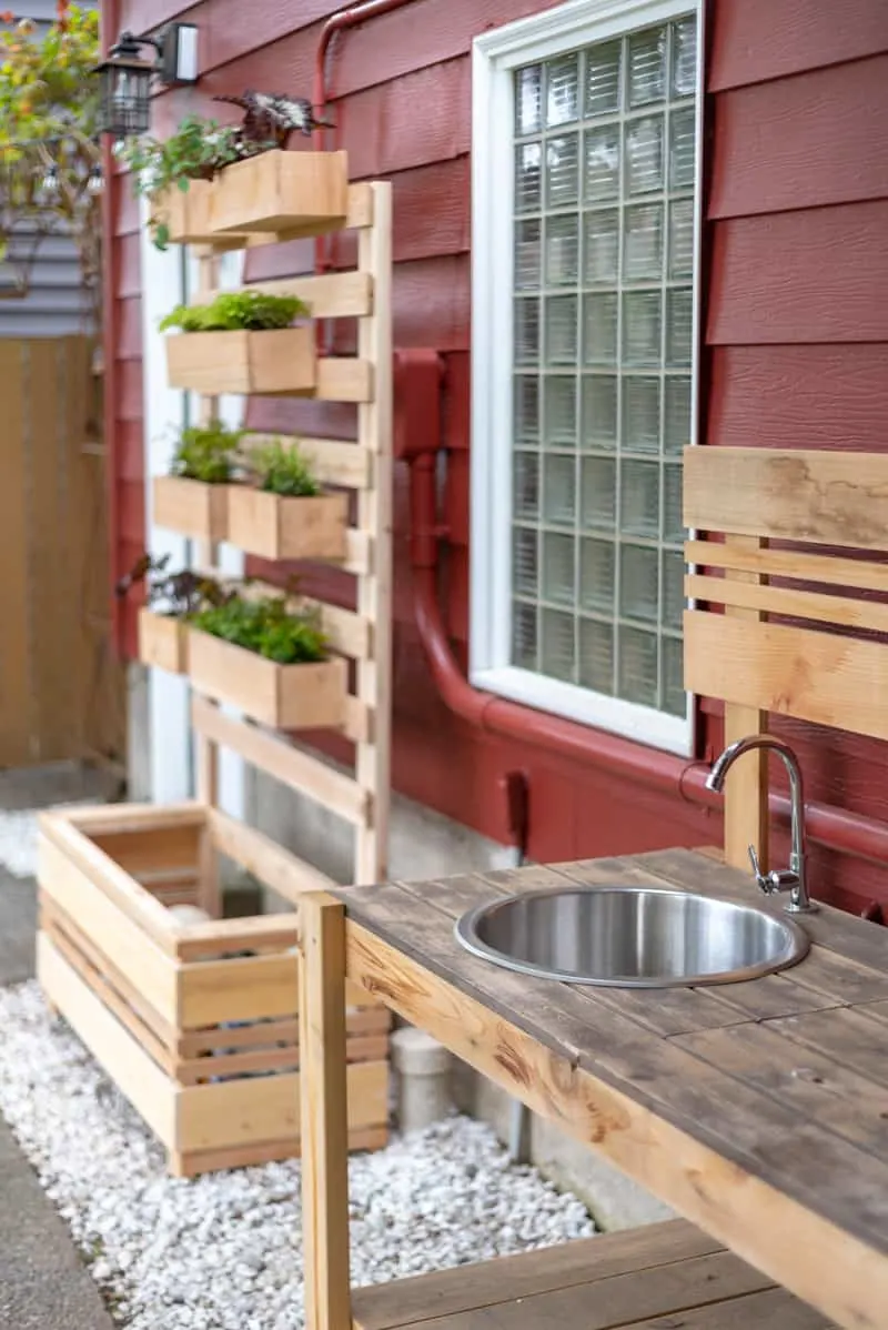 potting bench with sink and planter wall in background